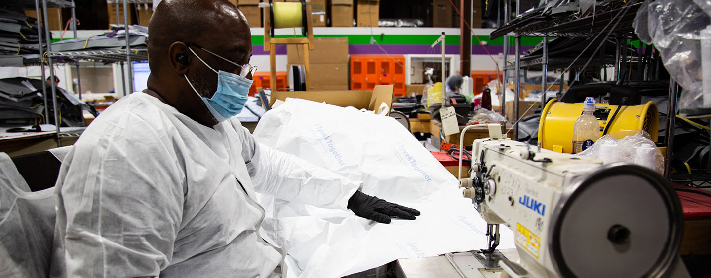 Worker sewing Tyvek