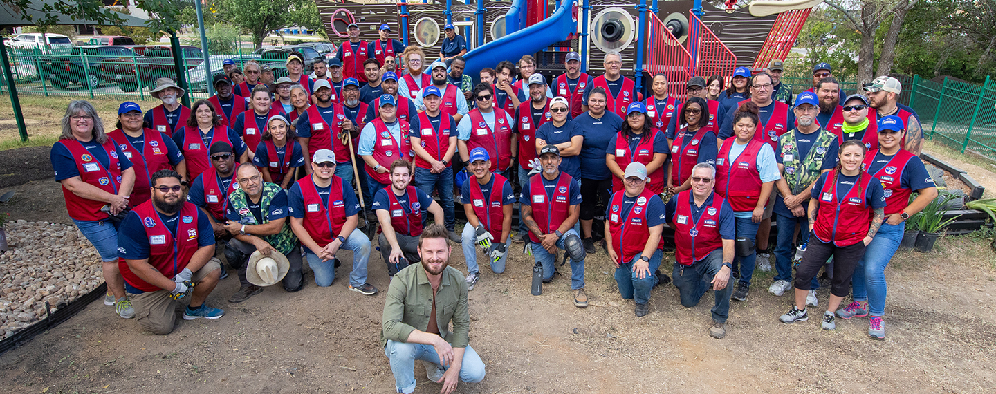 Bobby Berk with group of Lowe's red vest associates