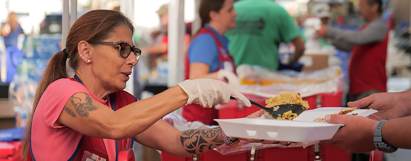 Lowe's red vest associate serving free Thanksgiving meal