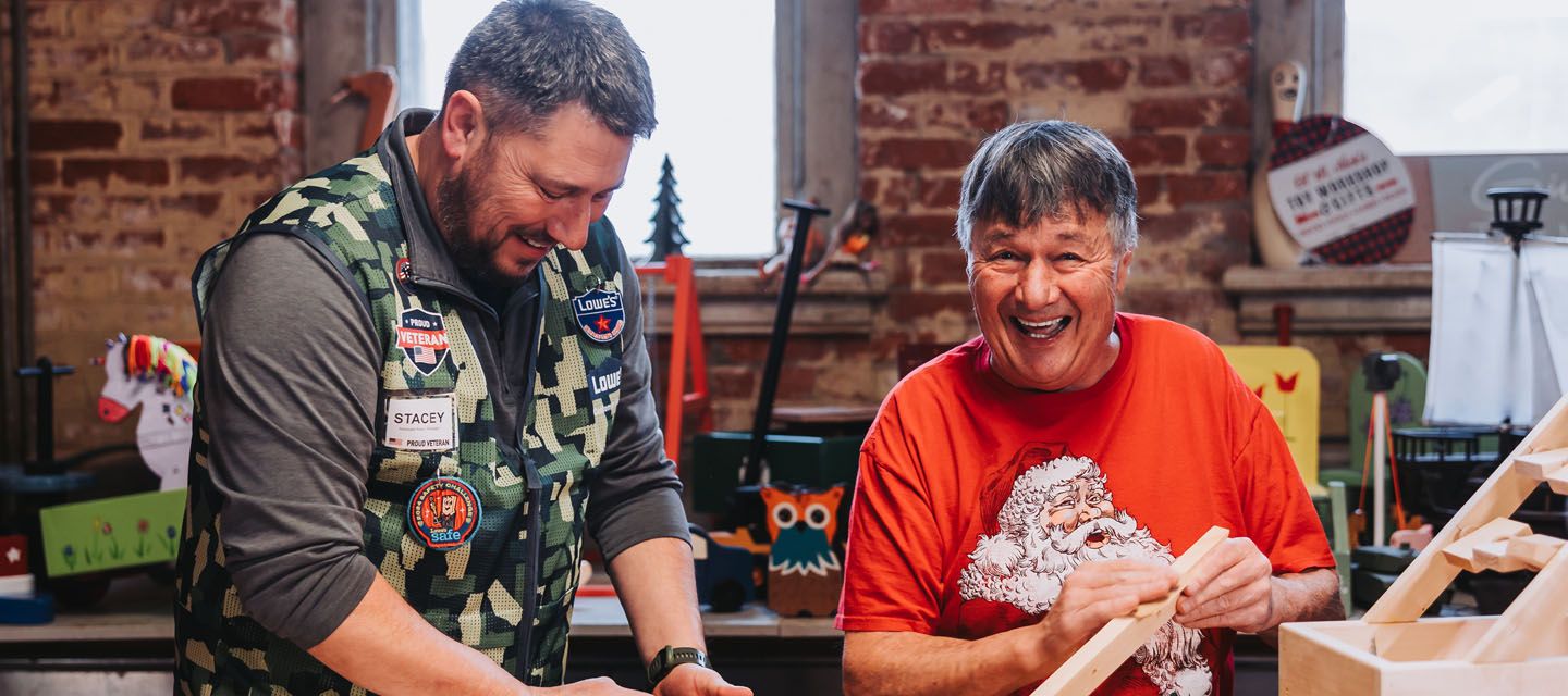 "Gary Olson works with Lowe's volunteers"