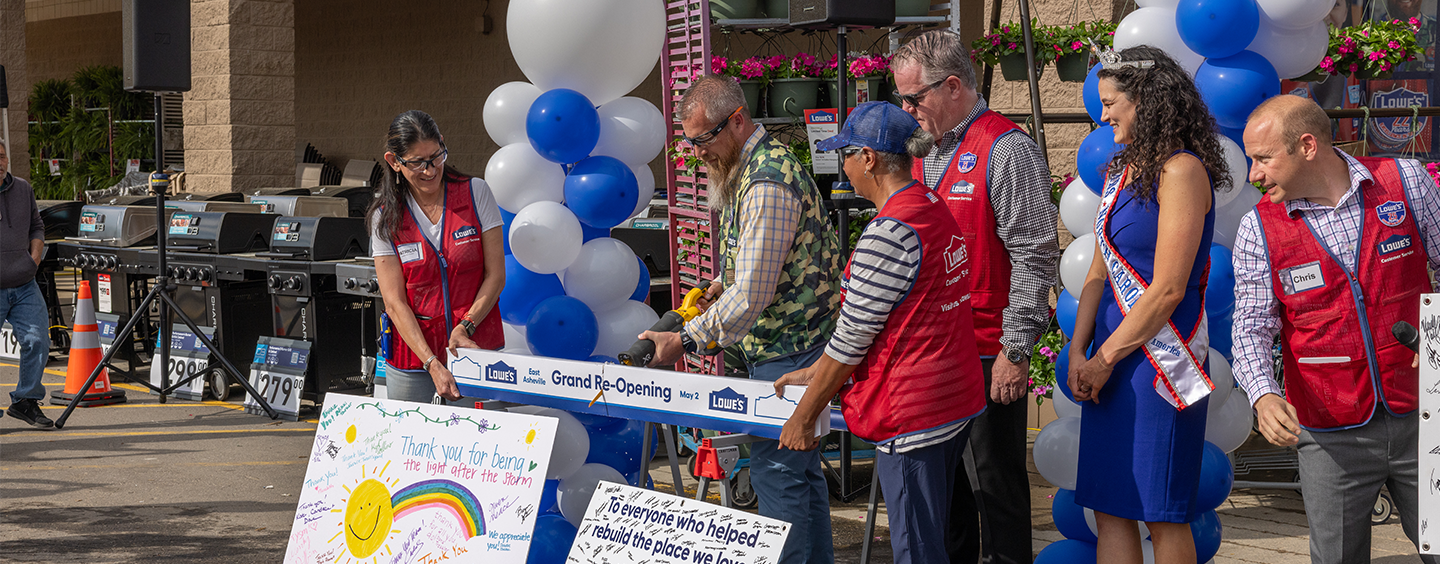 Board being cut at re-opening for Lowe's East Asheville location.
